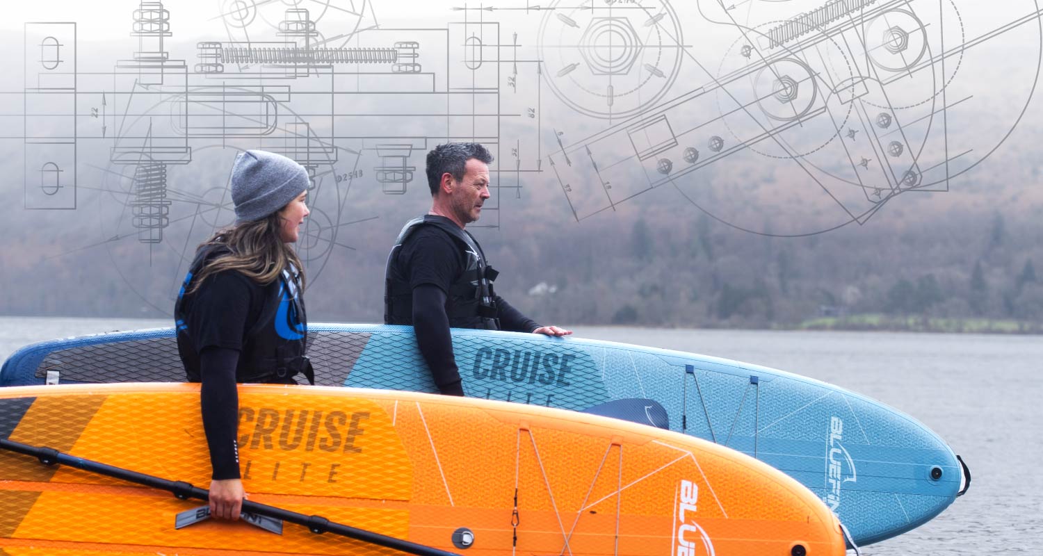 Two people holding inflatable paddleboards, one orange and one blue, with a technical drawing in the background.