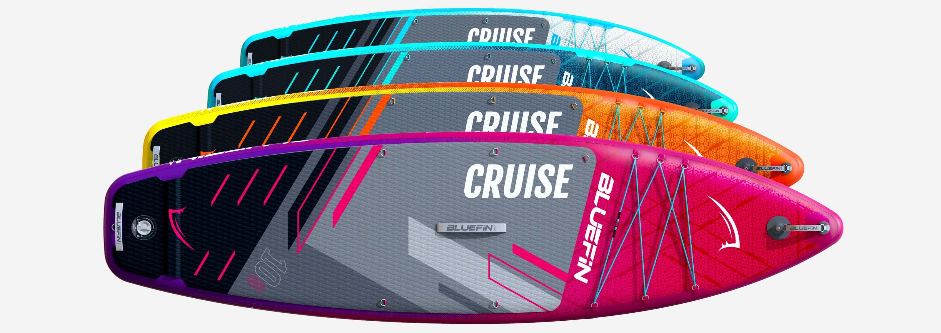 Four colorful inflatable paddleboards stacked, featuring textured decks and various designs.