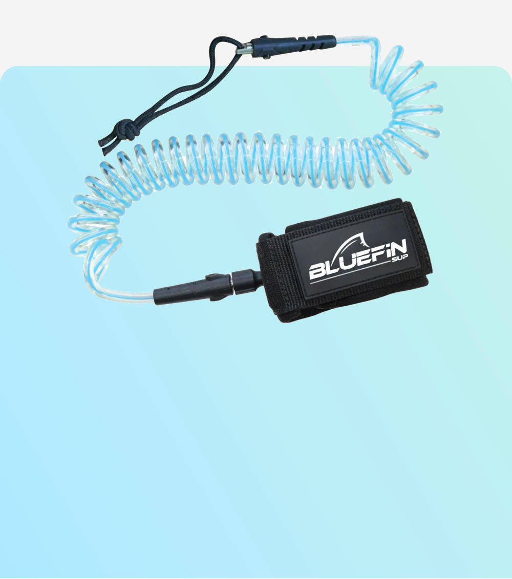 Coiled safety leash with black strap and Bluefin SUP logo, attached to a clear cord.