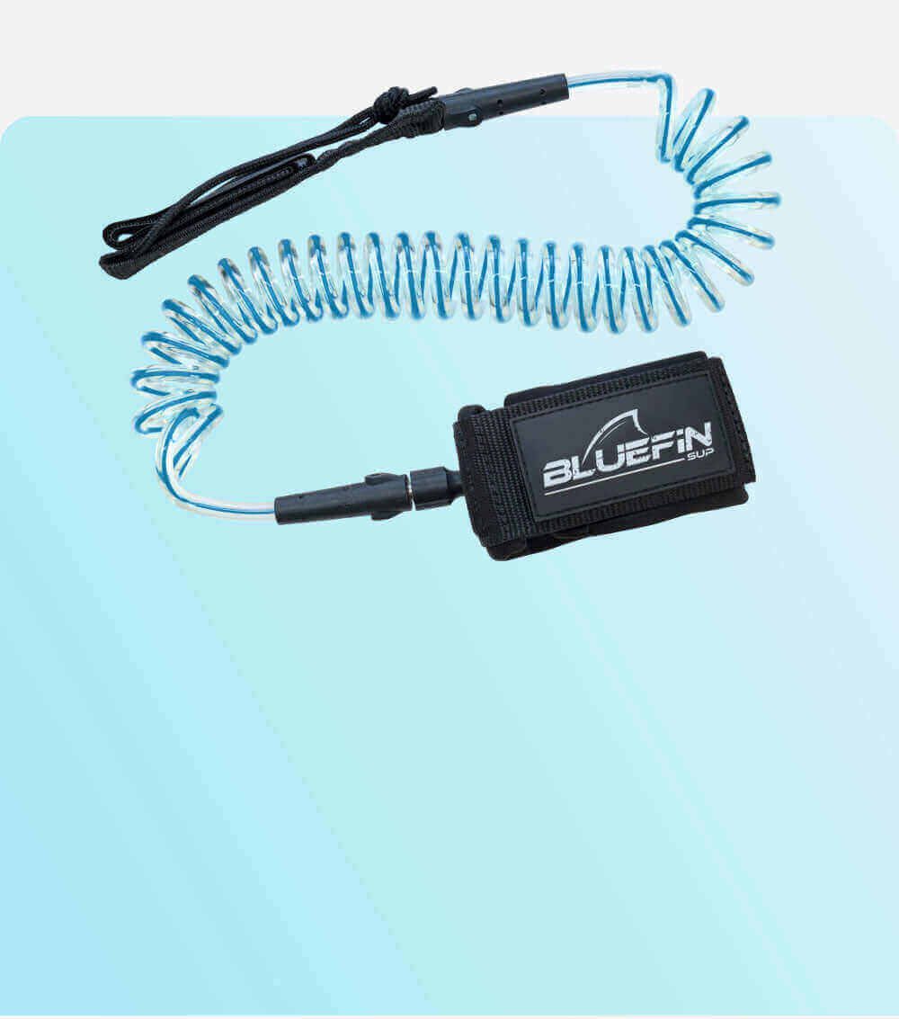 Coiled safety leash with black strap and blue cord, designed for paddleboarding use.