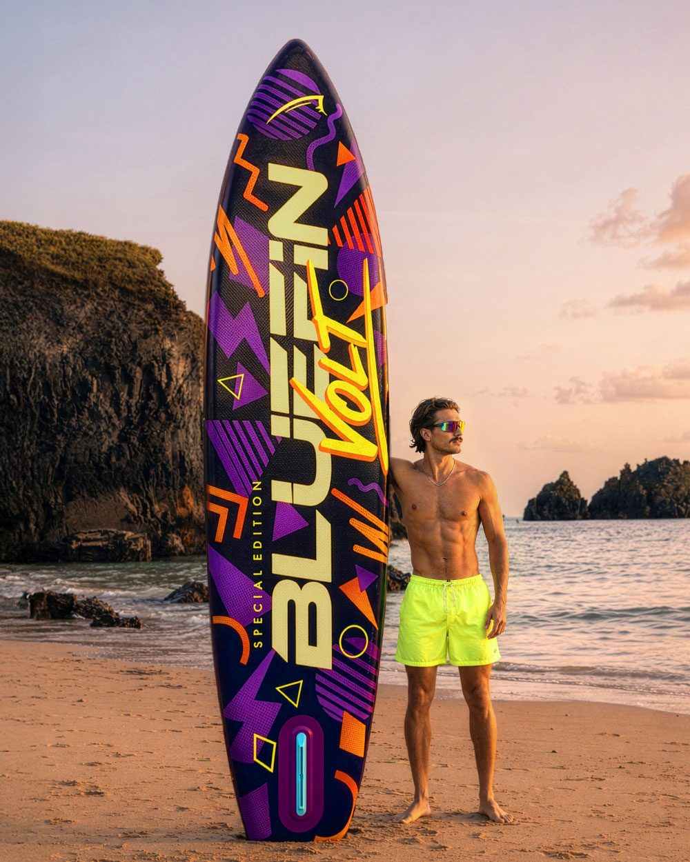 Colorful inflatable paddleboard with geometric designs, man in neon shorts standing on beach at sunset