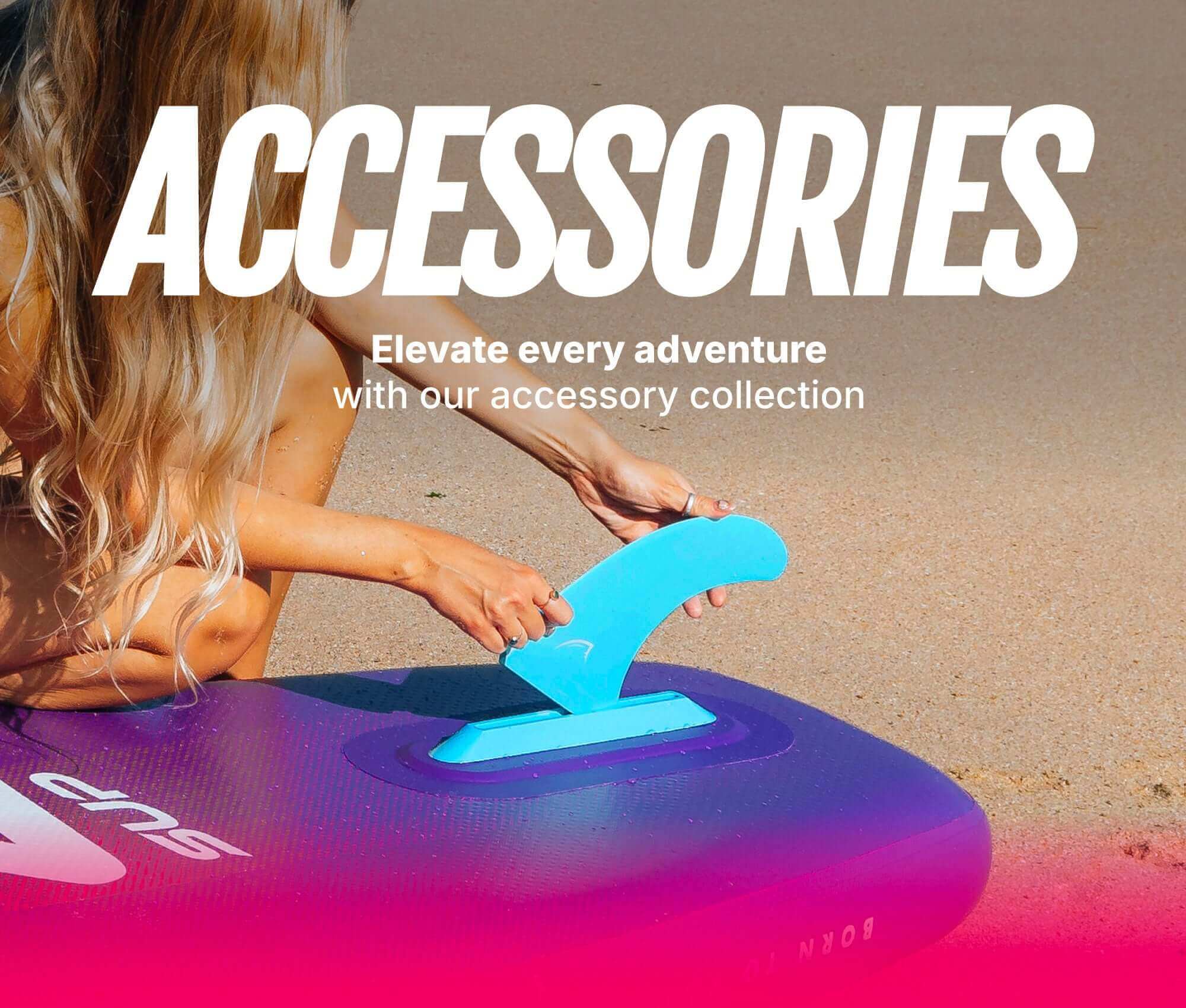 Person attaching a blue fin to a purple inflatable paddleboard on the beach