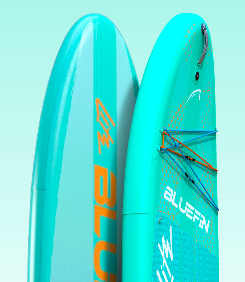 Two inflatable paddleboards in teal color with logos, one showing textured deck and bungee cords.