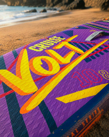 Inflatable paddleboard with vibrant purple design, featuring the words 'Cruise Volt 10.8' on the deck.